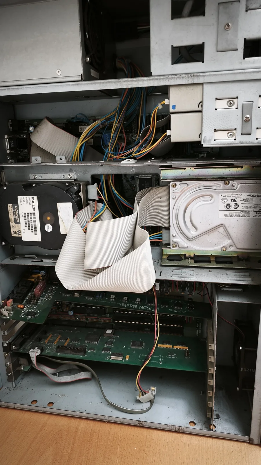 Opened Amiga 3000T from the inside: two SCSI hard drives in their brackets, ribbon cables, and the expansion cards on the mainboard below.
